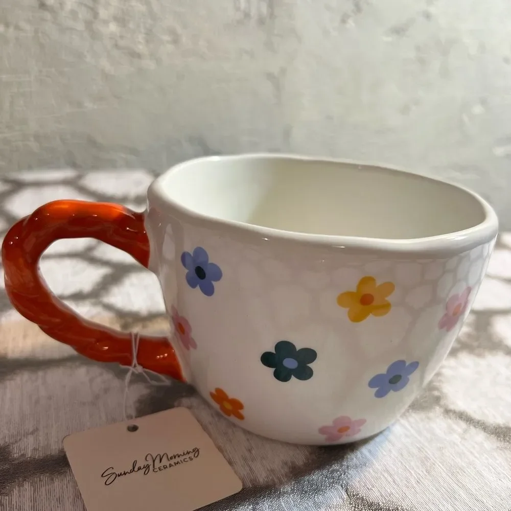 Artisan Mug with Floral Design and Orange Handle